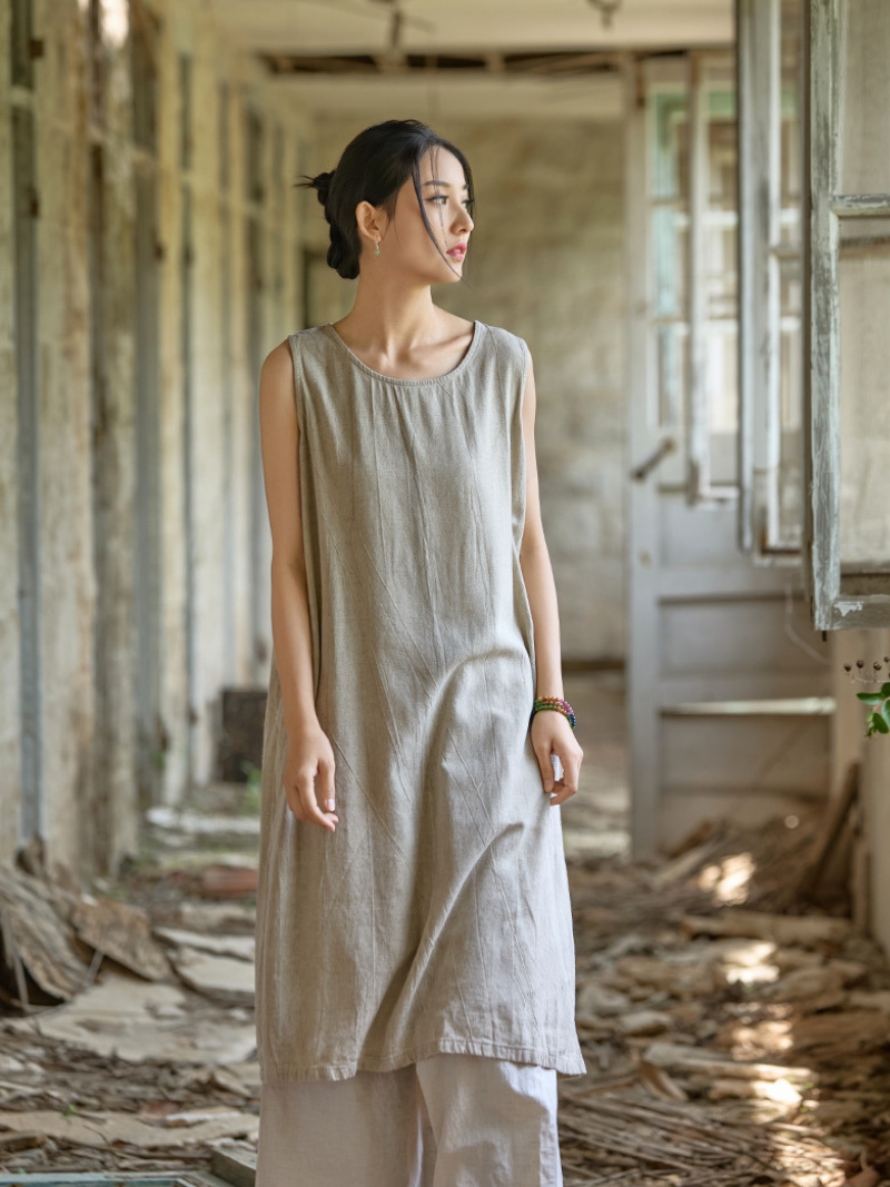 Woman wearing a light-colored dress in an abandoned building