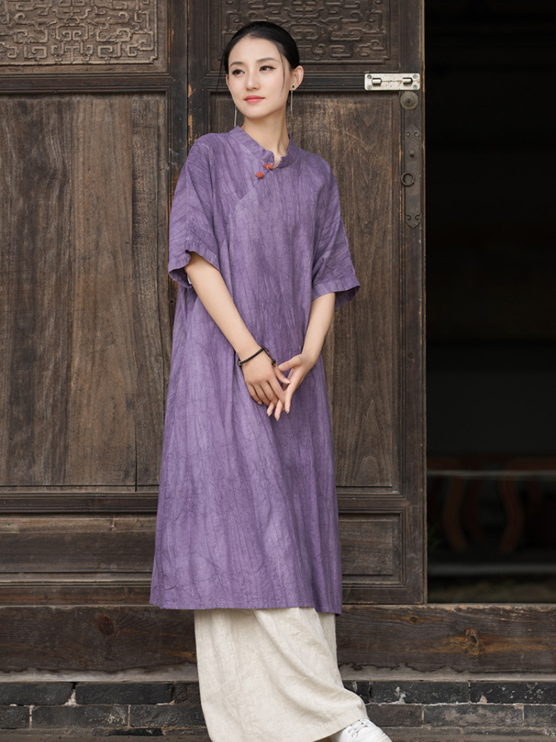 Woman wearing a purple dress standing 