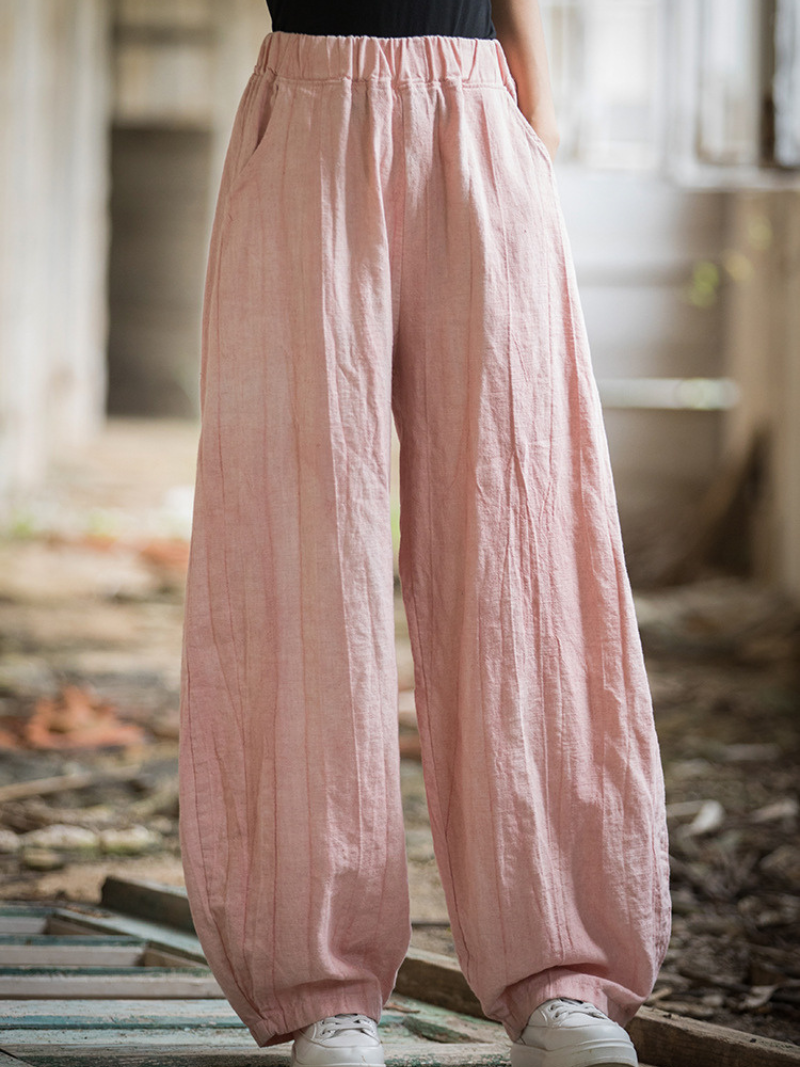 Women's wearing pink wide-leg pants in an outdoor setting