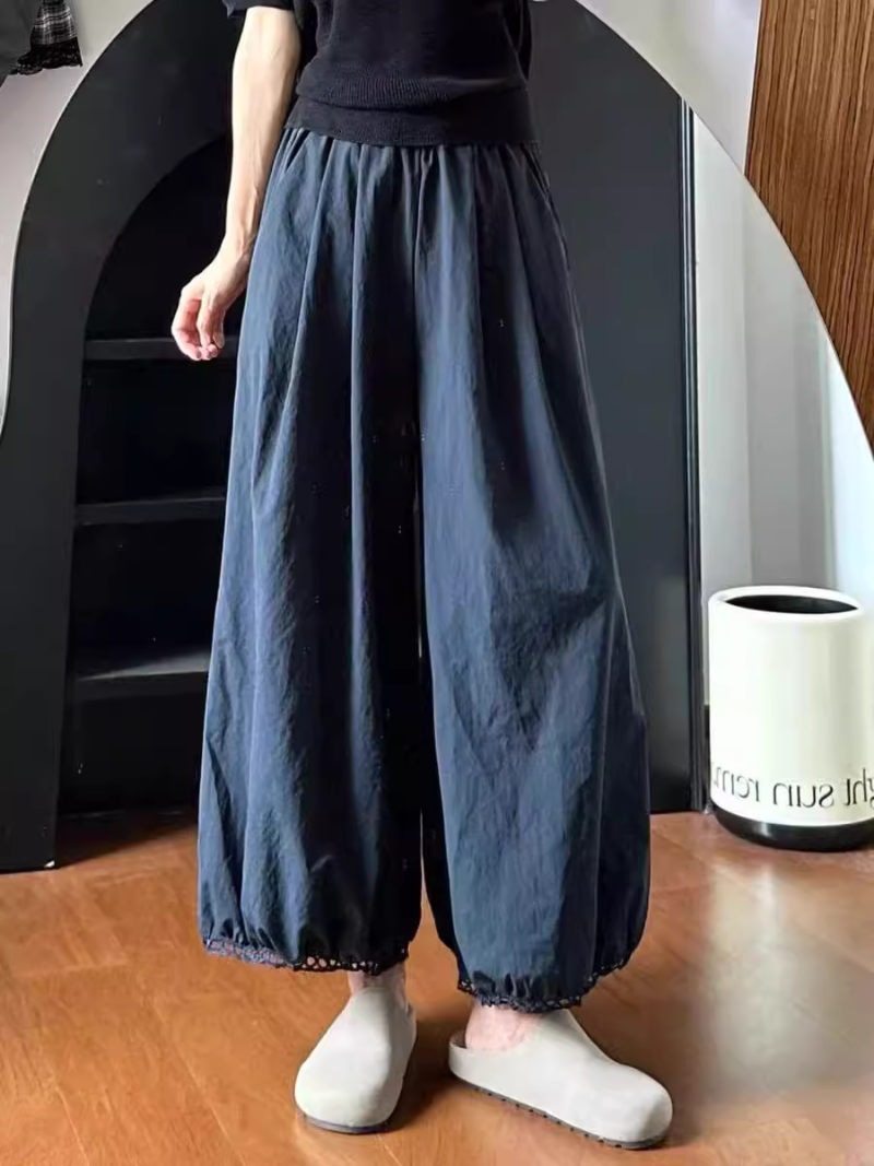 Women's wearing dark blue wide-leg pants and white shoes 