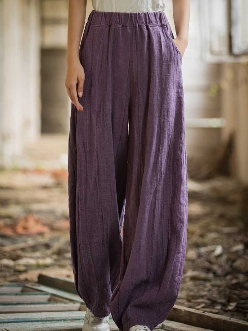  wearing purple wide-leg pants in an indoor