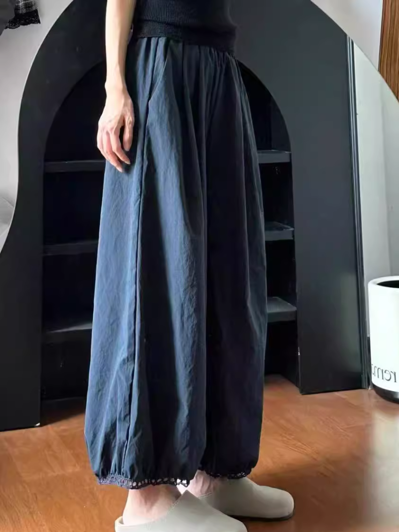  wearing dark blue wide-leg pants