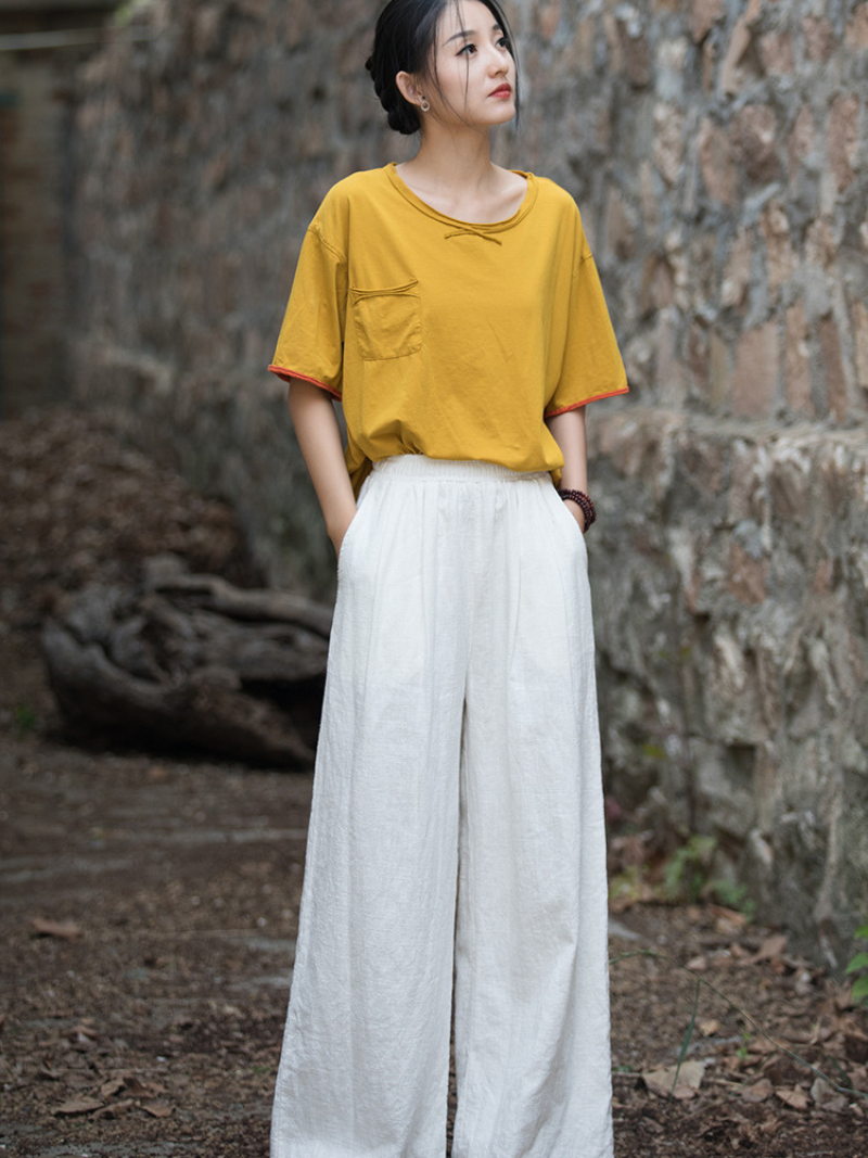 Woman wearing a yellow top and white pants 