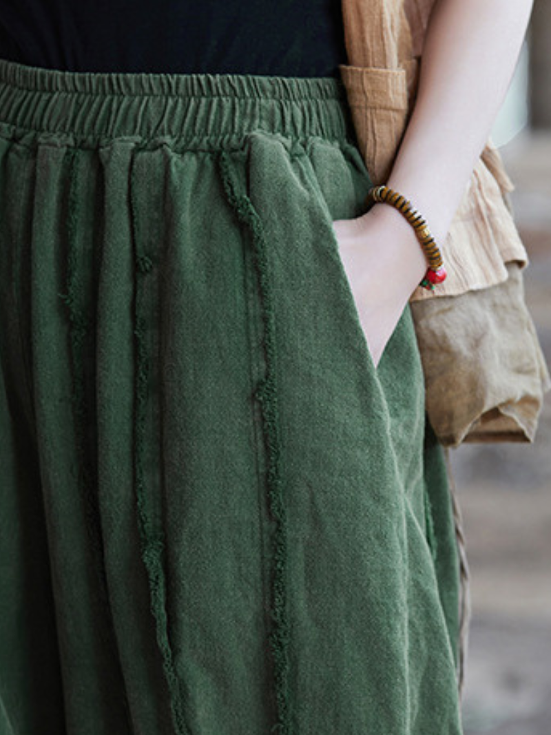 Women's  wearing a green skirt with a blurred background