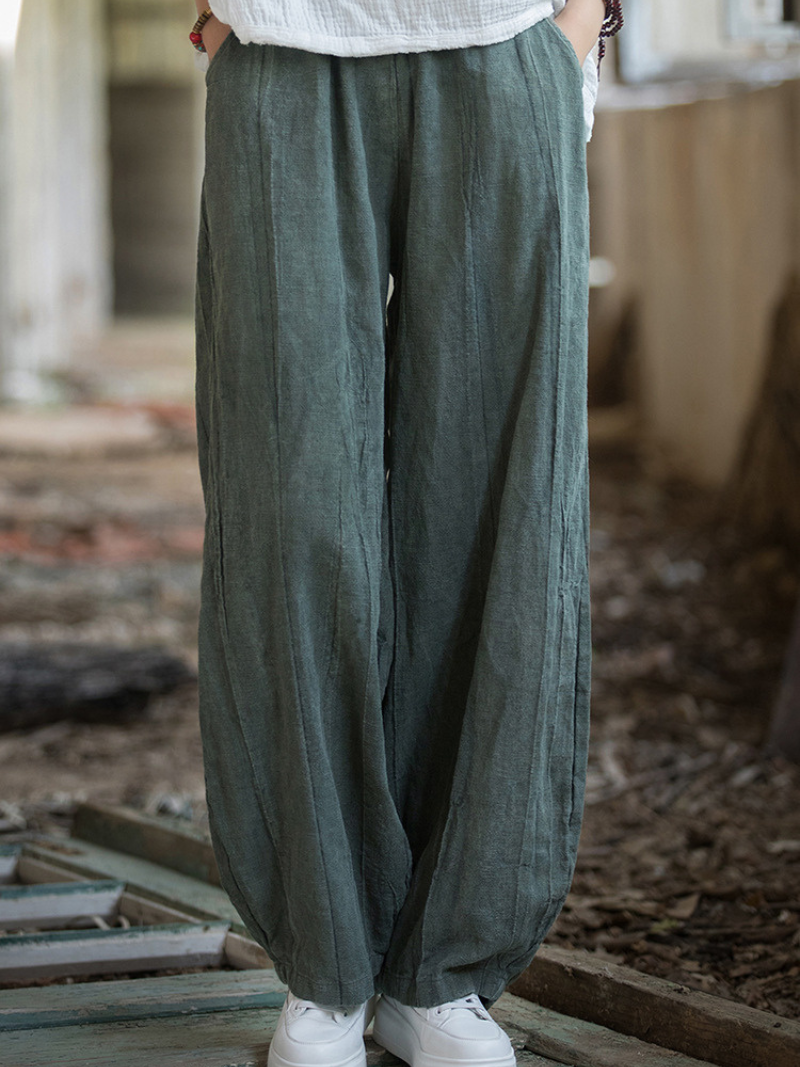 Women's wearing Blue wide-leg pants in an indoor setting with a blurred background